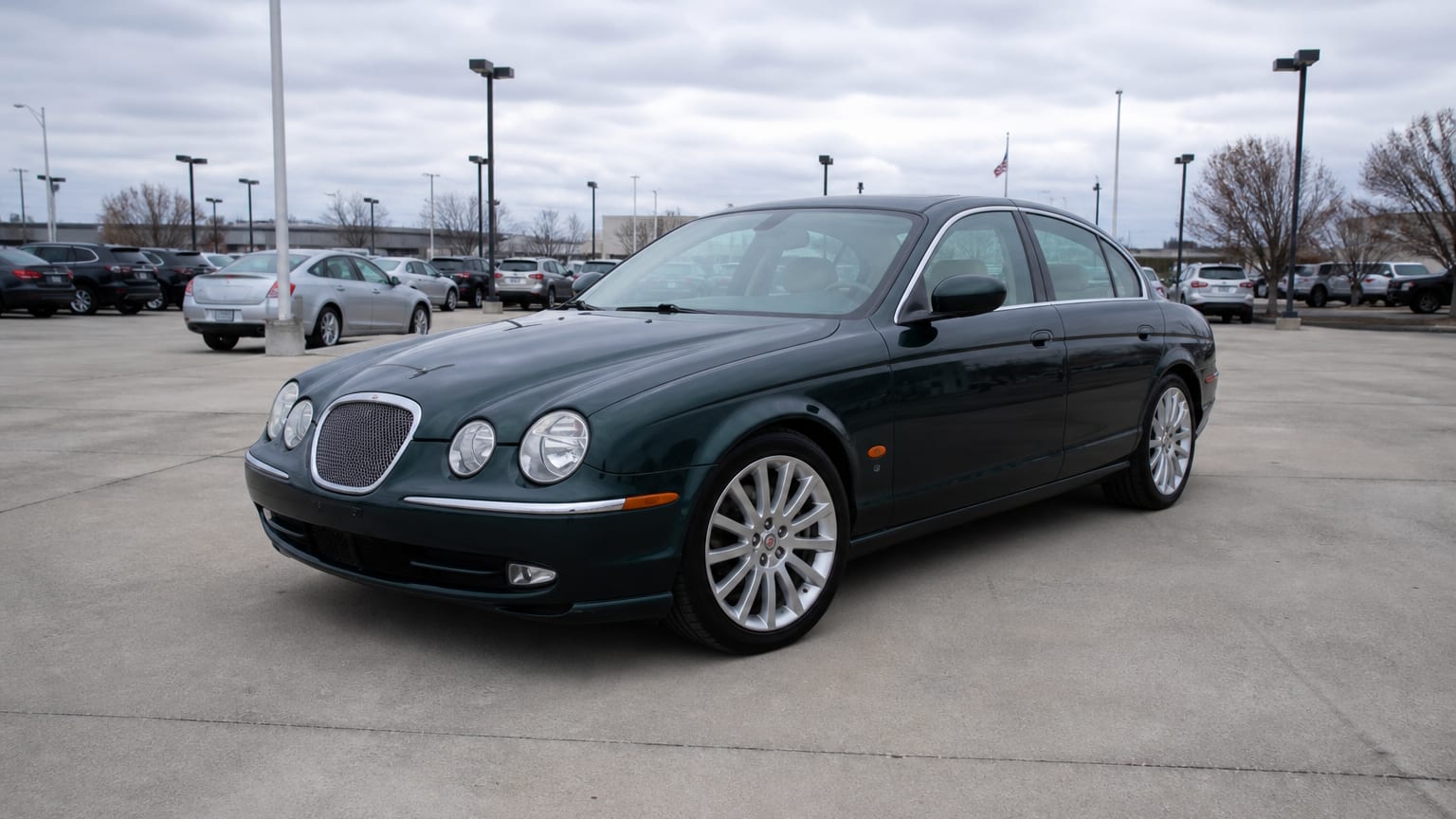 A higher-risk Jaguar XF model year parked in a dealership lot.