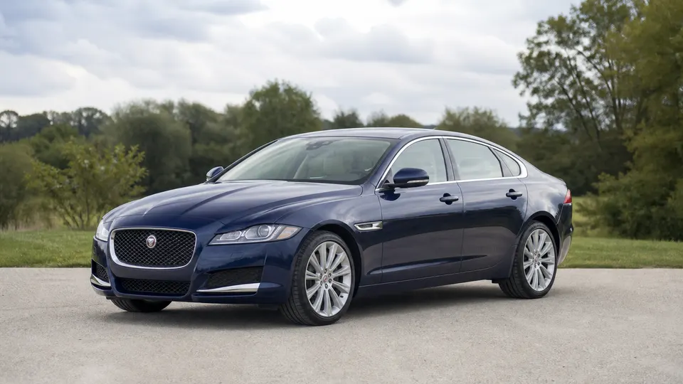 A Jaguar XF sedan, three-quarter front view, parked outdoors.