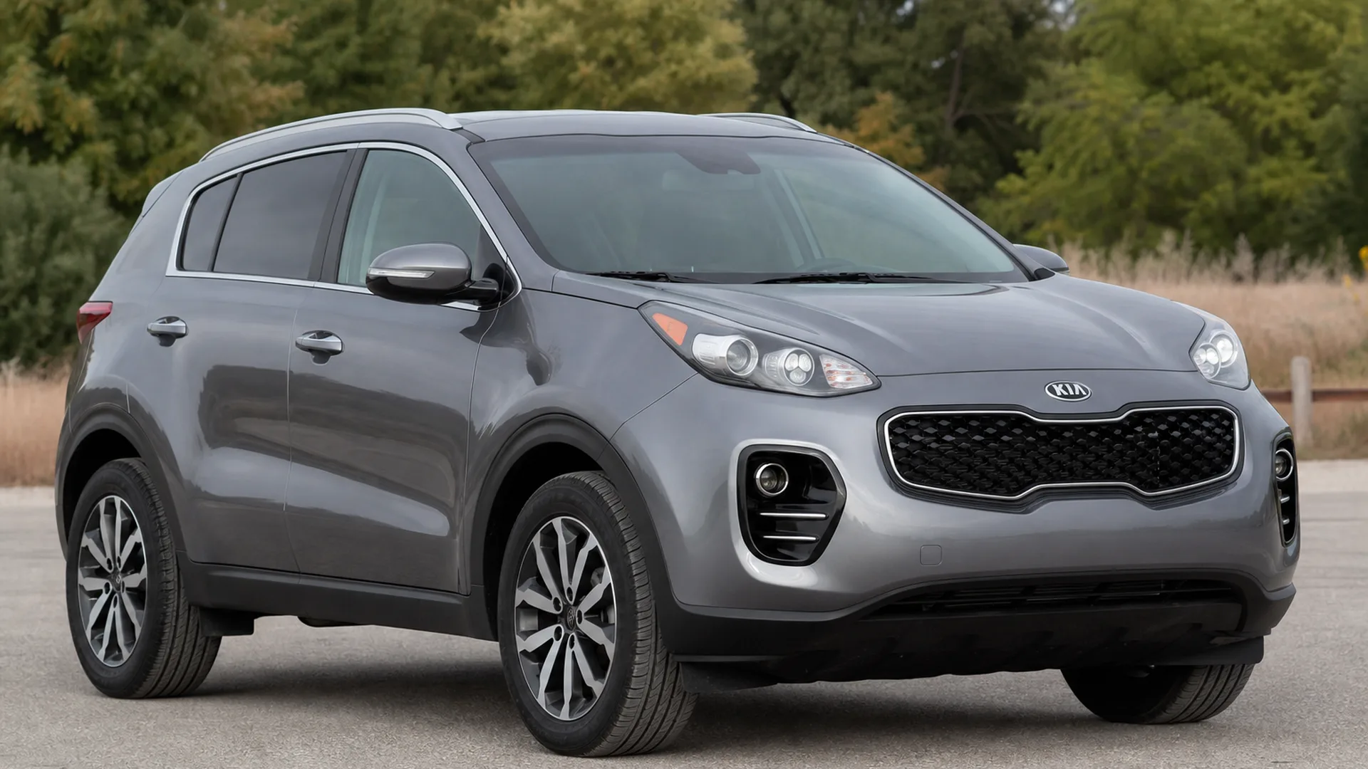 A grey Kia Sportage crossover parked outdoors.