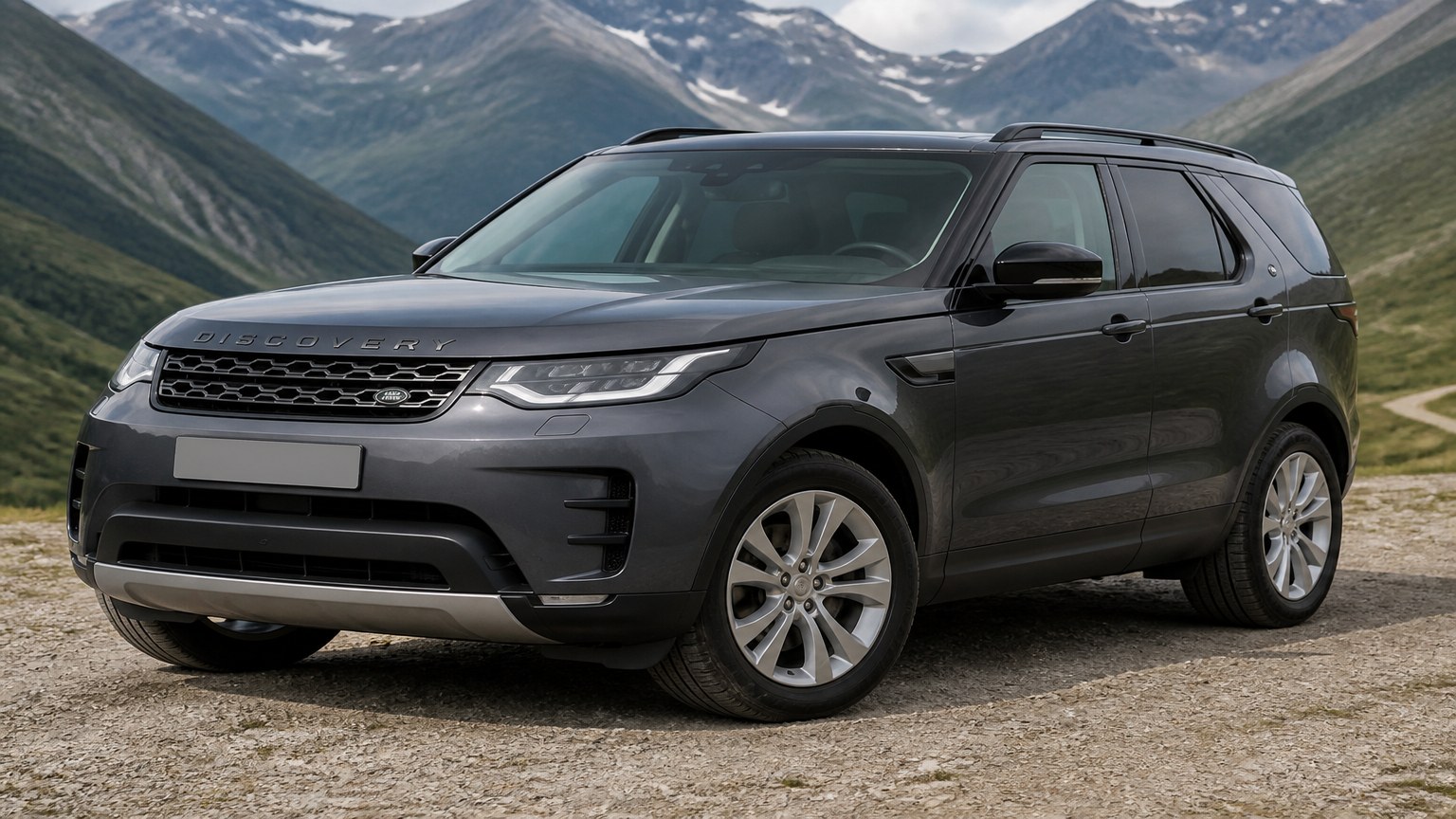 A cleaner later-model Land Rover Discovery on a quiet road.