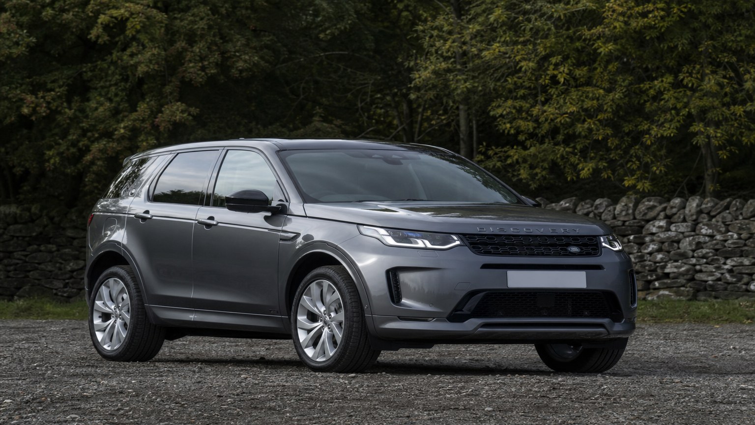 A cleaner later-model Land Rover Discovery Sport on a quiet road.