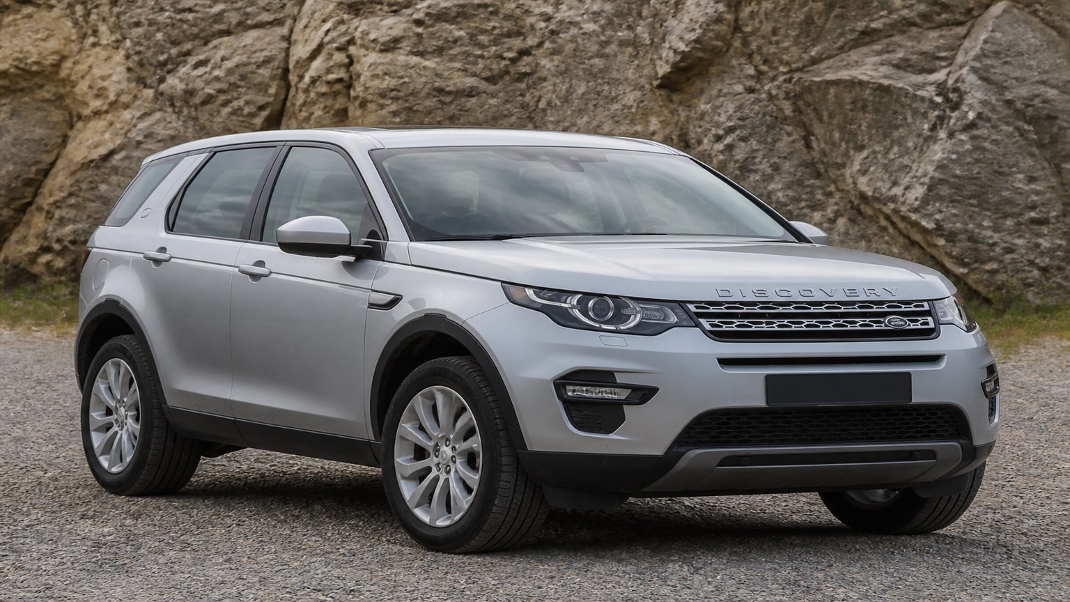A Land Rover Discovery Sport parked outdoors, three-quarter front view.