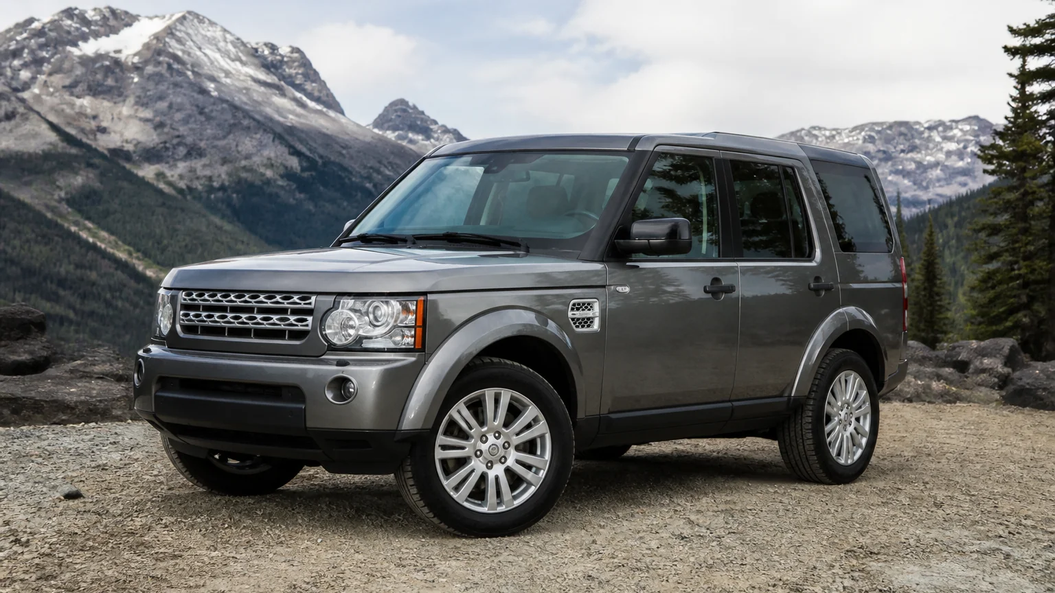 A Land Rover LR4 body-on-frame SUV, three-quarter front view, parked on a quiet street.