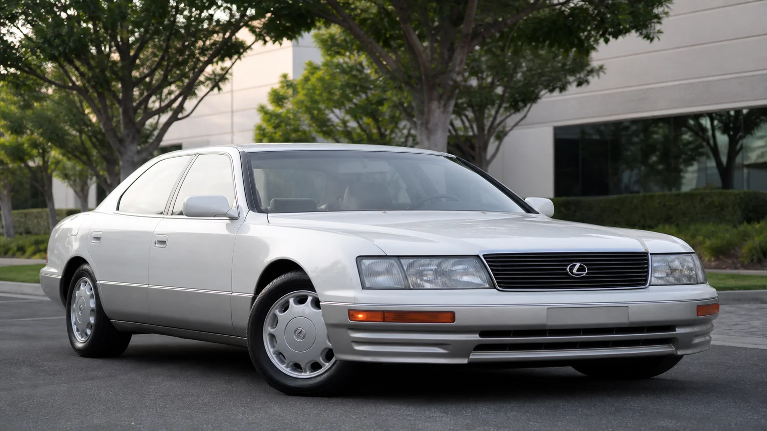 A Lexus LS 400 luxury sedan, three-quarter front view, parked on a quiet street.