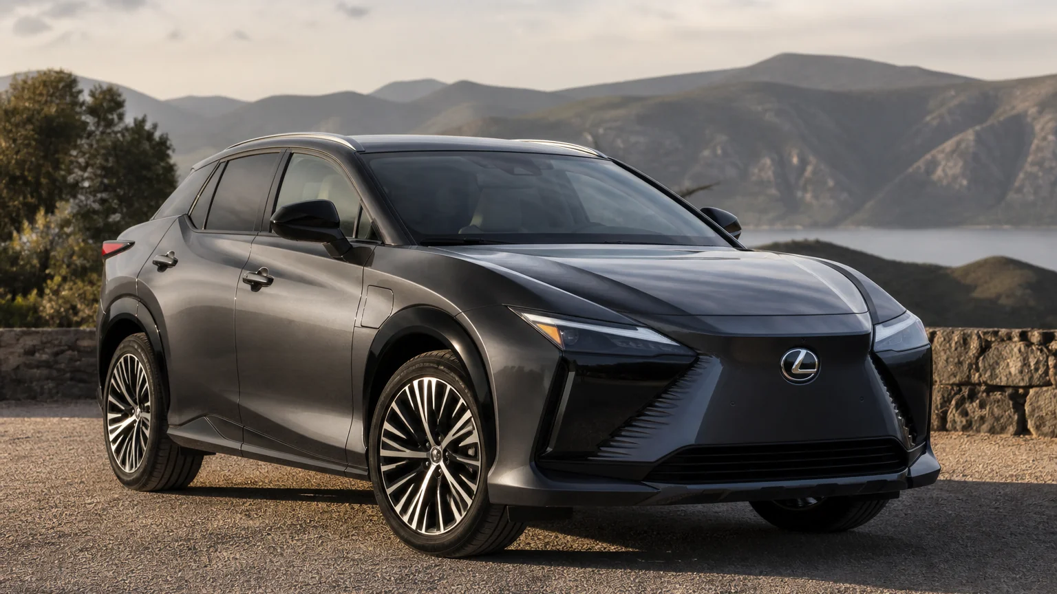 A Lexus RZ electric SUV, three-quarter front view, parked on a quiet street.
