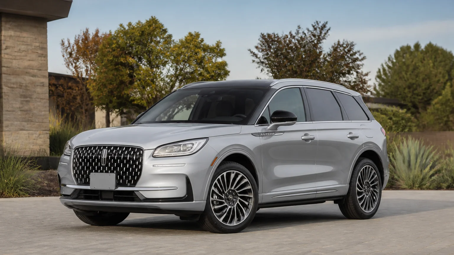 A Lincoln Corsair compact luxury SUV, three-quarter front view, parked on a quiet street.