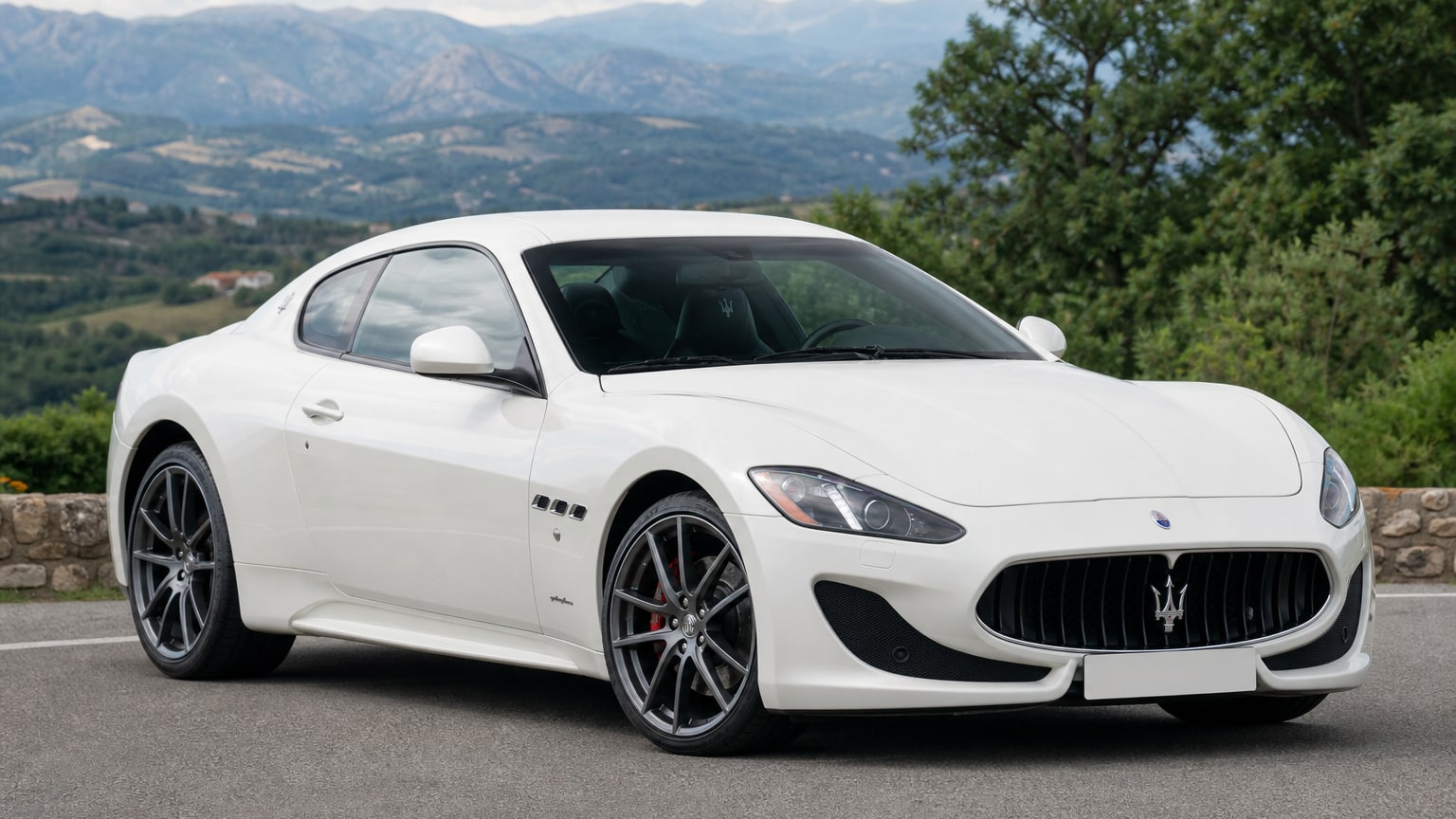 A cleaner later-model Maserati GranTurismo on a quiet road.