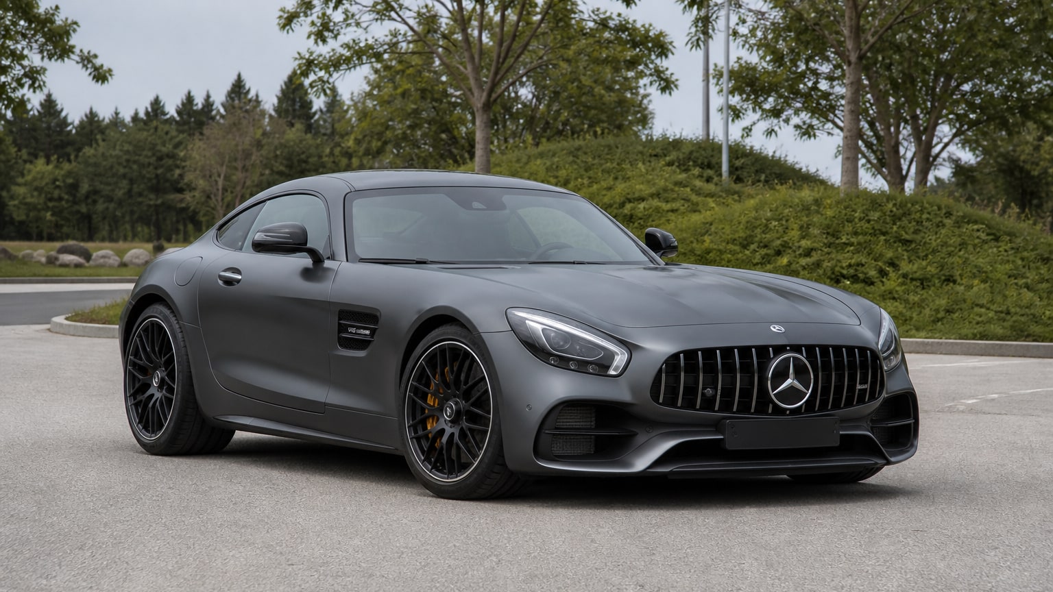 A Mercedes-Benz AMG GT parked outdoors, three-quarter front view.