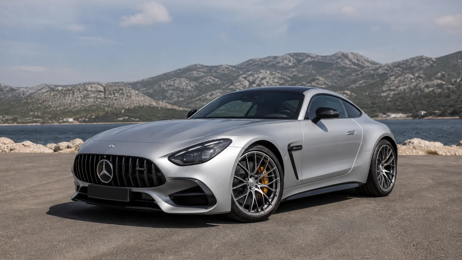 A Mercedes-Benz AMG GT, three-quarter front view, parked outdoors.
