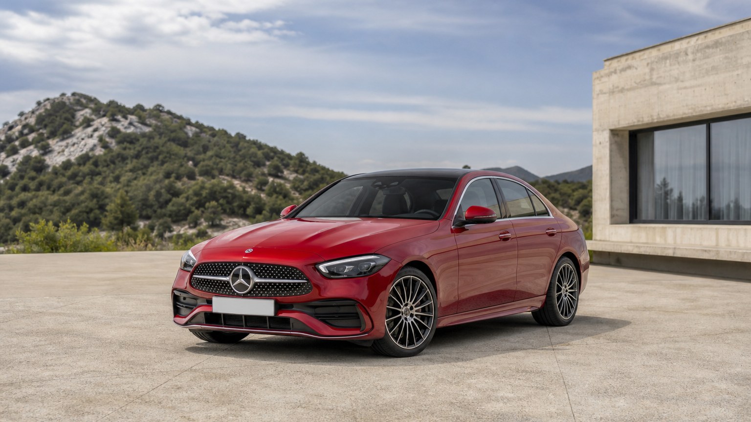 A cleaner later-model Mercedes-Benz C-Class on a quiet road.
