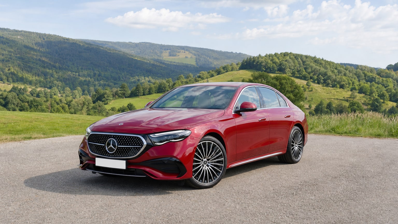 A cleaner later-model Mercedes-Benz E-Class on a quiet road.