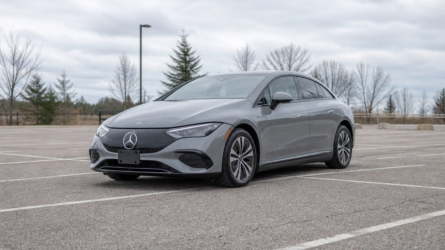 A higher-risk Mercedes-Benz EQE model year parked in a dealership lot.