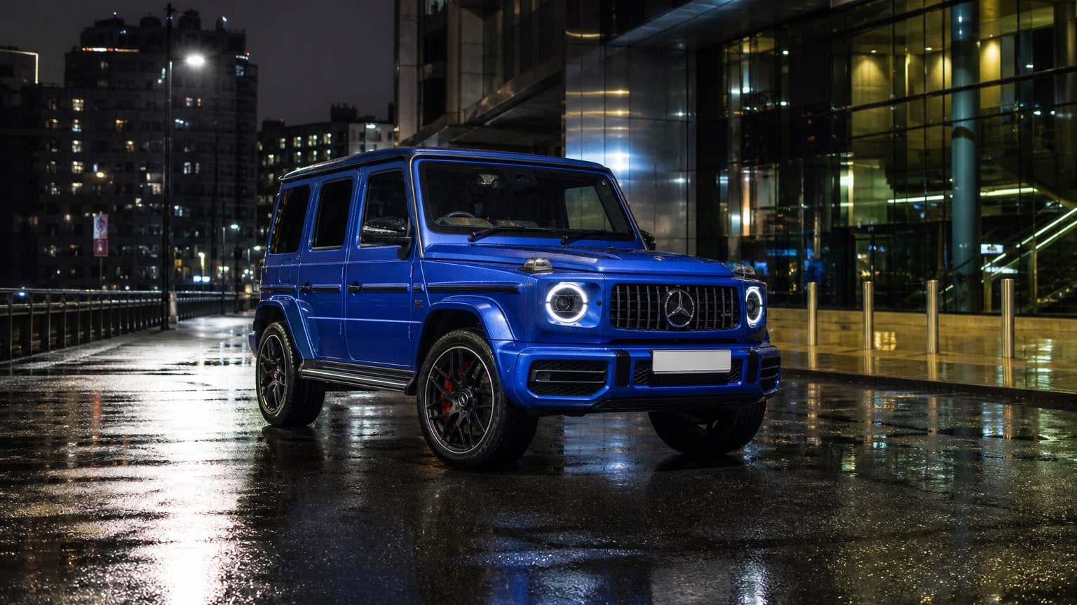 A cleaner later-model Mercedes-Benz G-Class on a quiet road.
