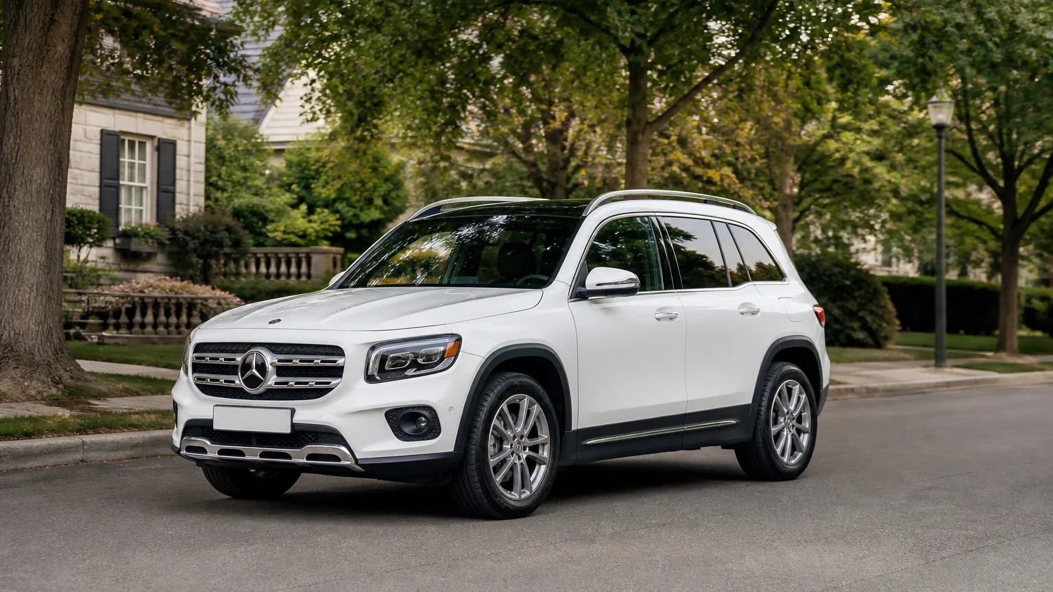 A Mercedes-Benz GLB compact luxury SUV, three-quarter front view, parked on a quiet street.