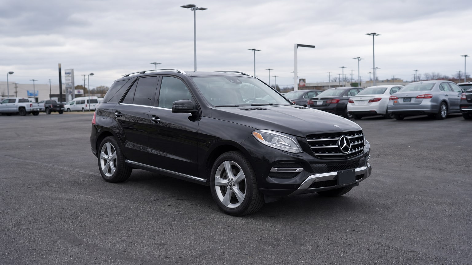 A higher-risk Mercedes-Benz GLE model year parked in a dealership lot.