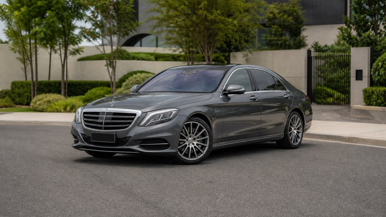 A cleaner later-model Mercedes-Benz S-Class on a quiet road.