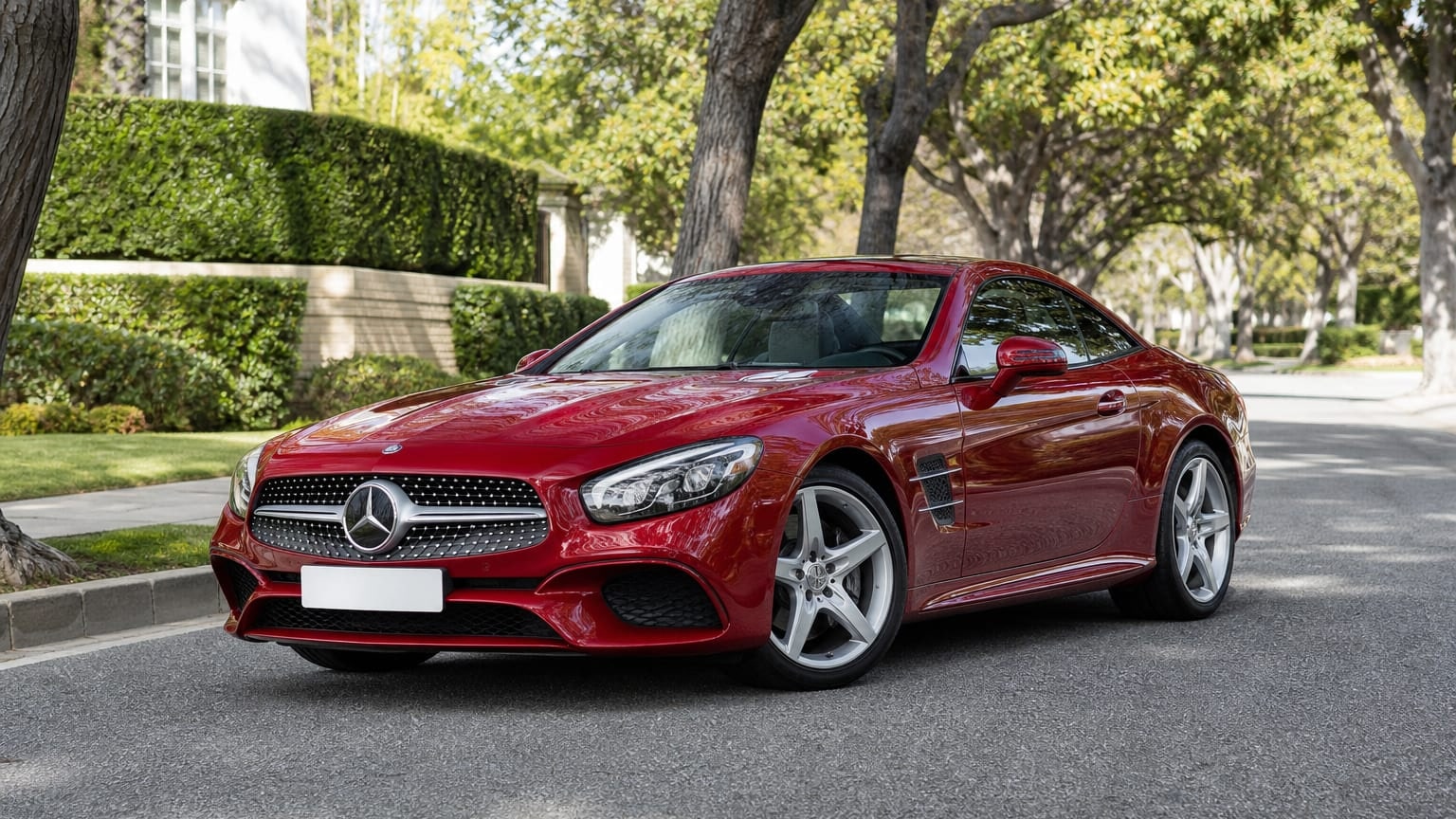 A cleaner later-model Mercedes-Benz SL on a quiet road.