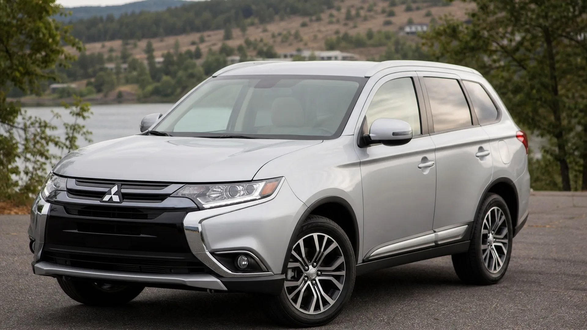 A silver Mitsubishi Outlander crossover parked outdoors.