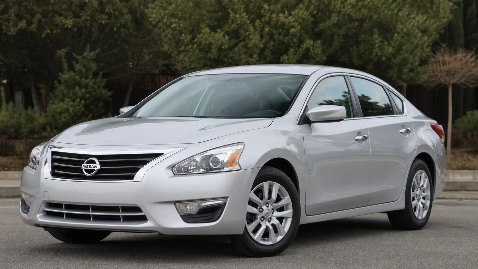A silver Nissan Altima sedan parked outdoors.