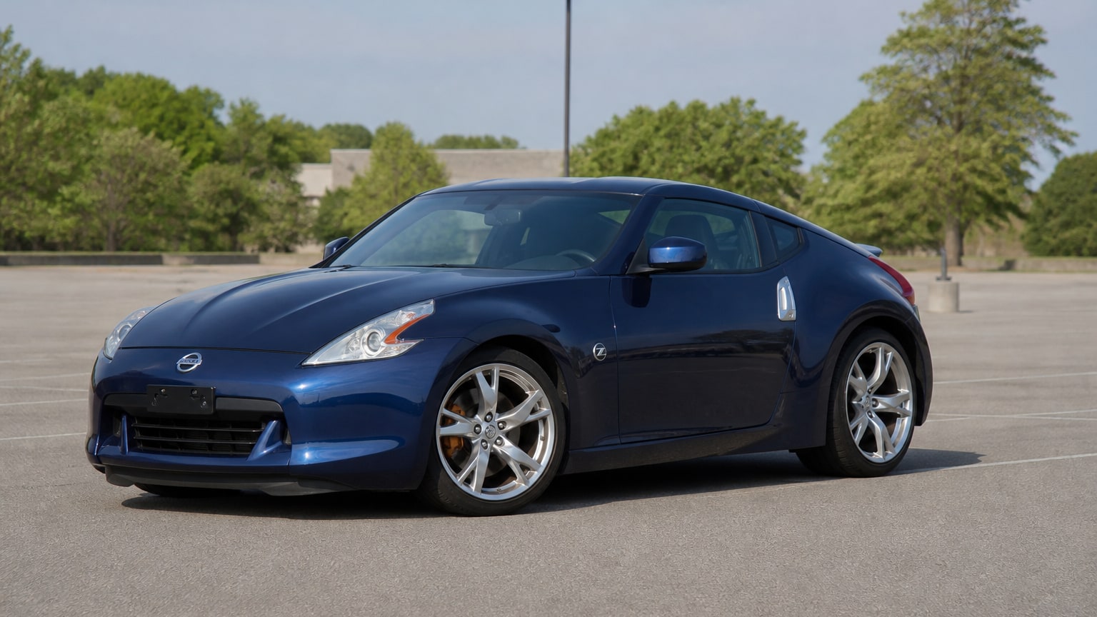 A higher-risk Nissan Z model year parked in a dealership lot.