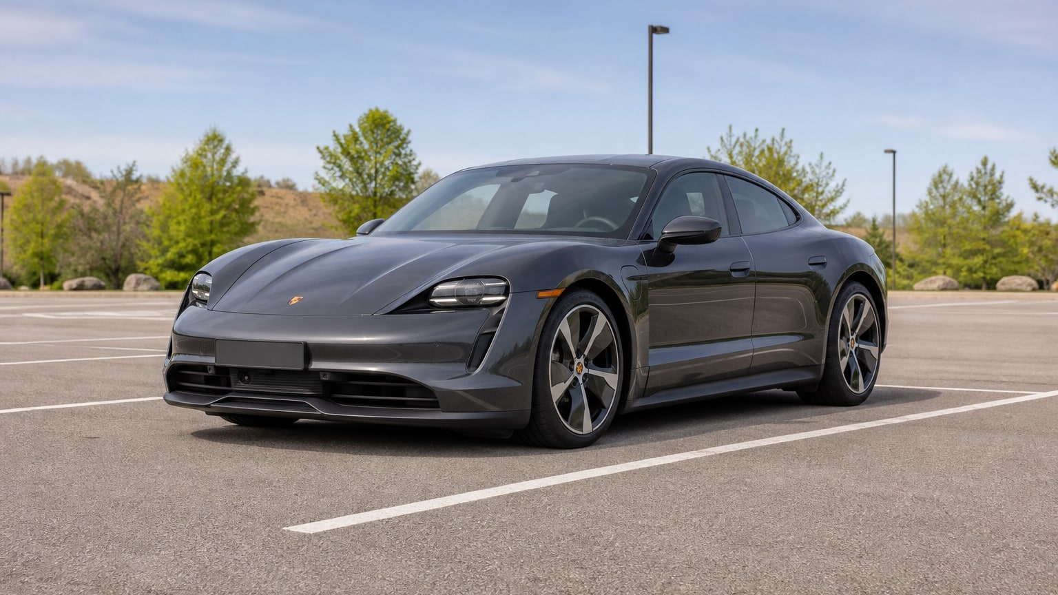 A higher-risk Porsche Taycan model year parked in a dealership lot.