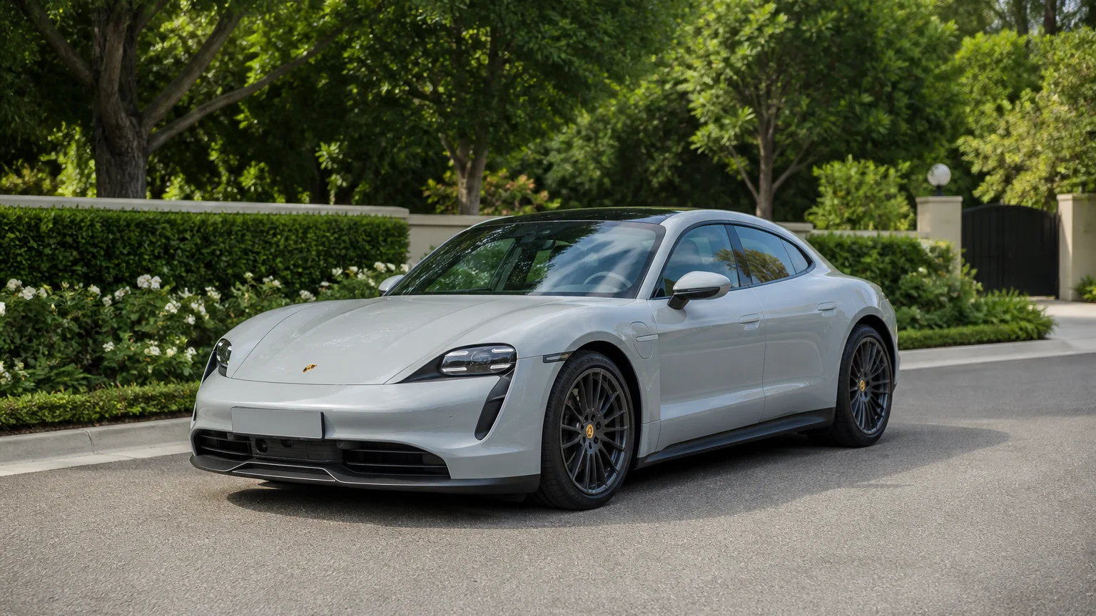 A Porsche Taycan, three-quarter front view, parked outdoors.