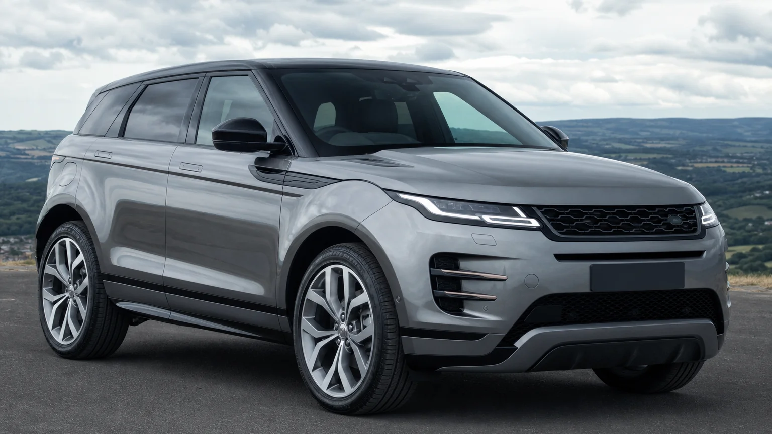 A Range Rover Evoque compact luxury SUV, three-quarter front view, parked on a quiet street.