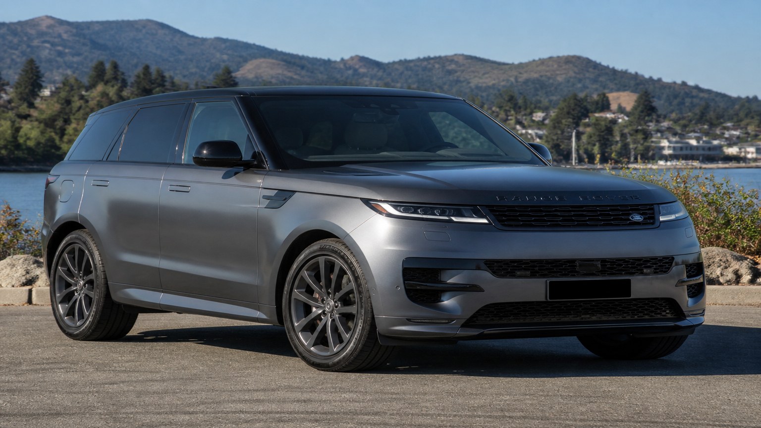 A cleaner later-model Range Rover Sport on a quiet road.