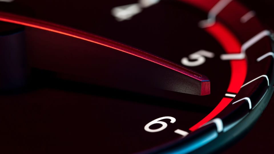 a close up of a red and blue clock face.