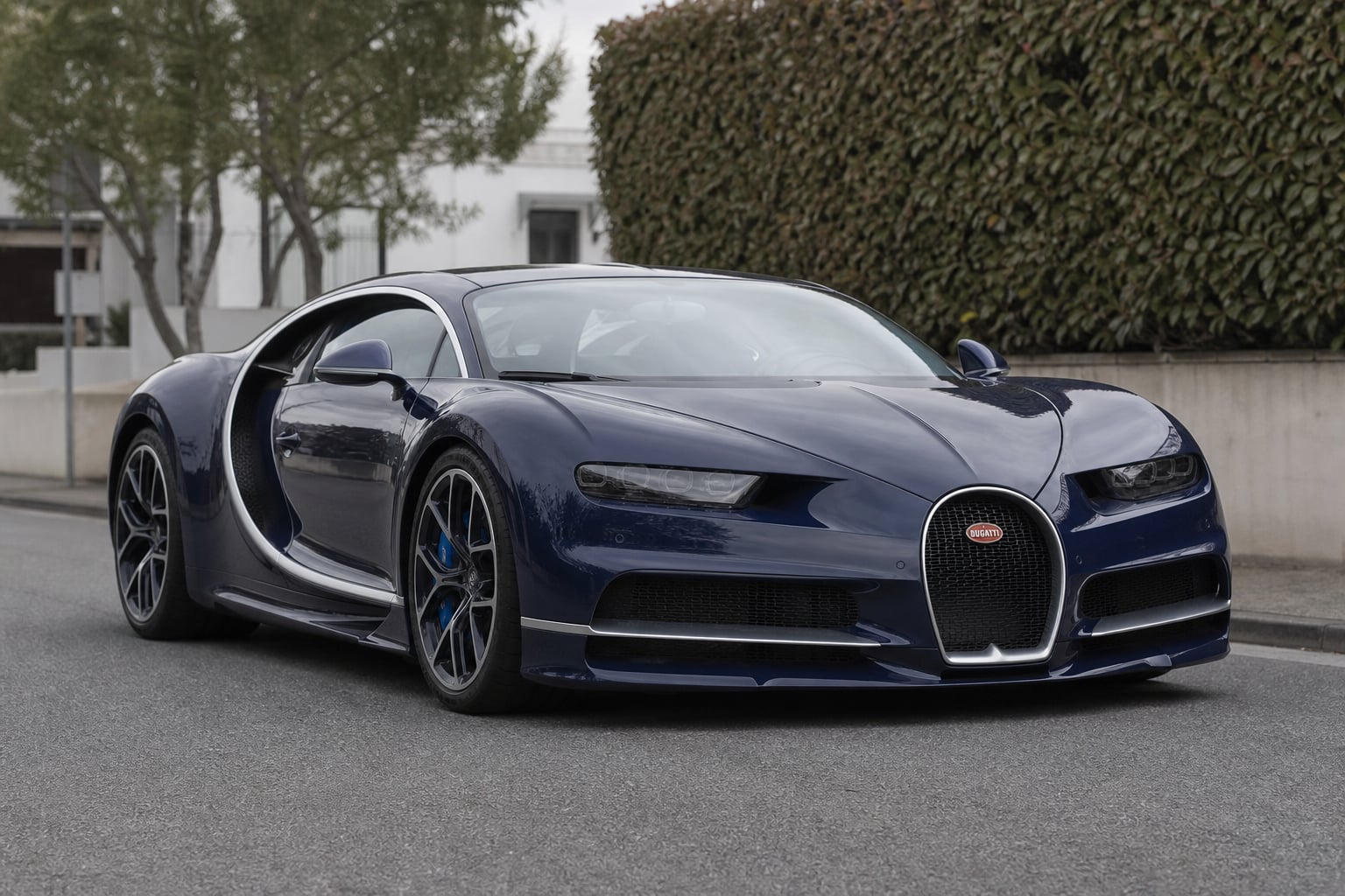 Dark blue Bugatti hypercar parked on a quiet street