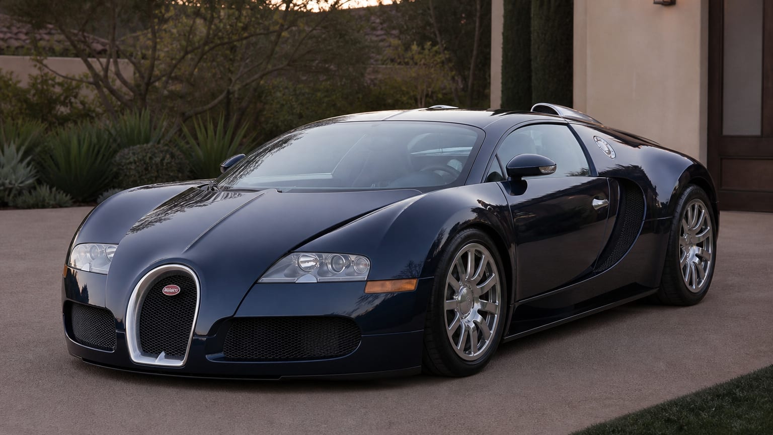 Dark blue Bugatti Veyron hypercar on a private driveway