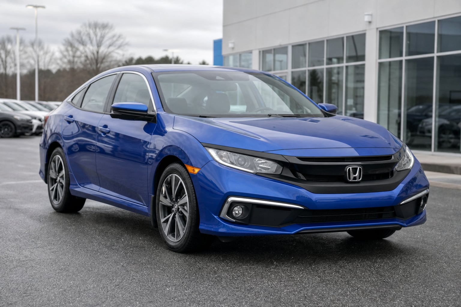 Blue Honda Civic sedan parked at a dealership