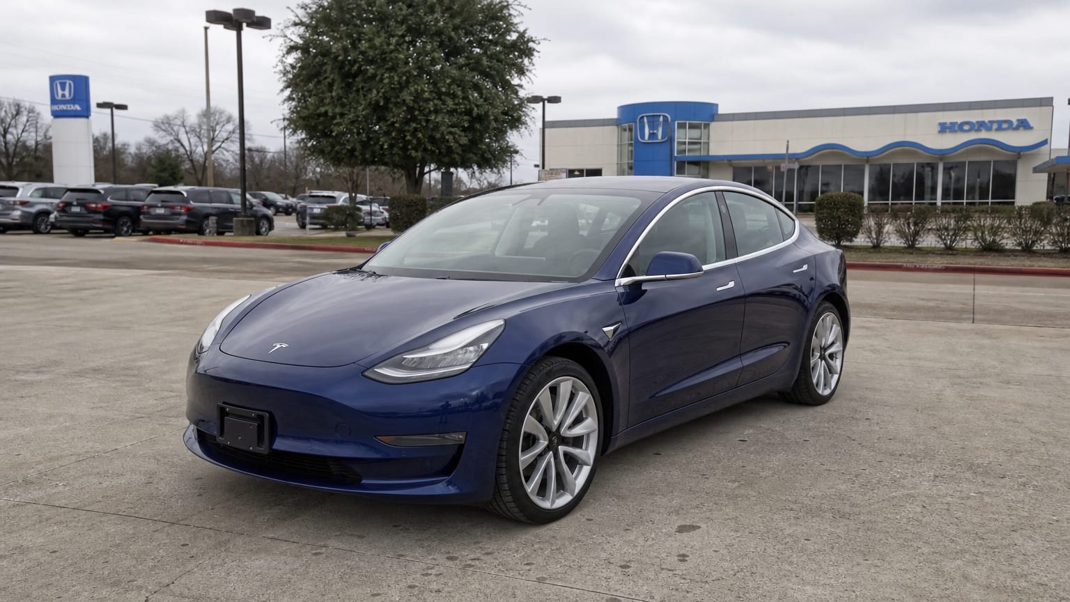 A higher-risk Tesla Model 3 model year parked in a dealership lot.
