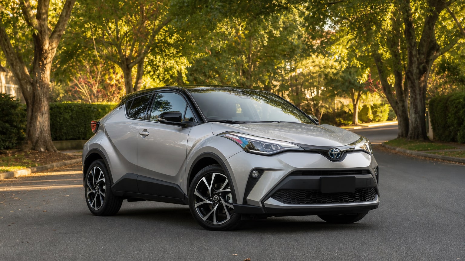 A cleaner later-model Toyota C-HR on a quiet road.