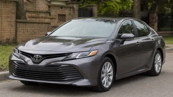 A grey Toyota Camry sedan parked on a street.