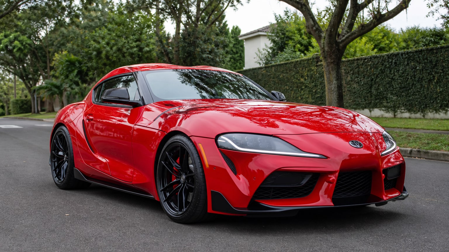 A cleaner later-model Toyota Supra on a quiet road.