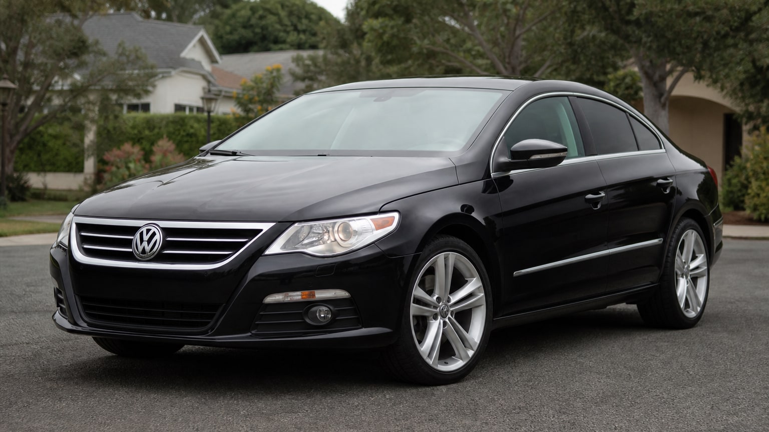 A black Volkswagen CC coupe-sedan parked on a quiet street.